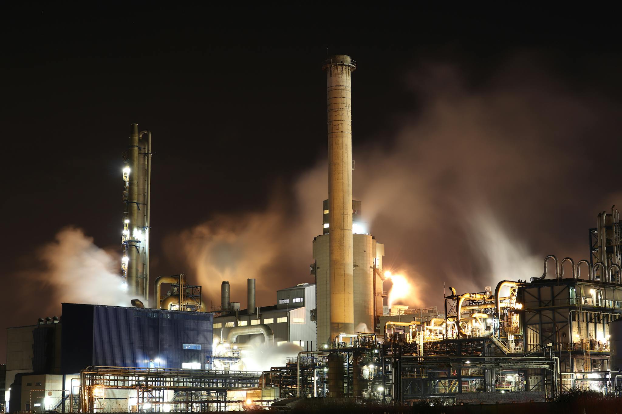 brown and white factory building during night